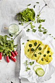 Green herb pancakes, radishes, and salt