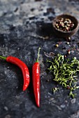 Red chili peppers, peppercorns, and herbs