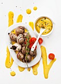 Snails with yellow garlic sauce (top view)
