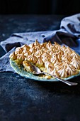 A plate of lemon meringue pie with a spoon