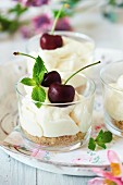 Cheesecake in glasses with cherries