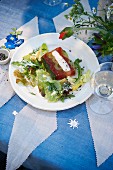 Zander terrine with tomatoes, blanched celery, and herbs, served with a cream dressing and a small salad garnish