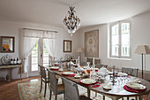 Festively set oval dining table in French-style dining table