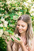 Woman holding white flowers