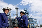 Two industrial workers on oil and gas refinery