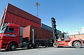 Forklift truck lifting shipping container
