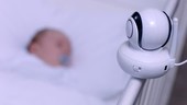 Baby in cot with monitor