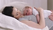 Baby lying on mother's chest