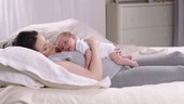 Baby lying on mother's chest