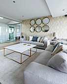 Glamorous living room in shades of Champagne with glass wall