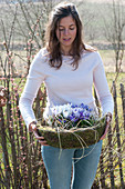 Woman carrying a basket with Crocus