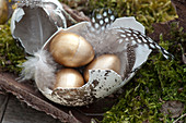 Unusual Easter table decoration with golden Easter eggs