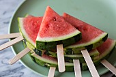 Wedges of watermelon on lollipop sticks