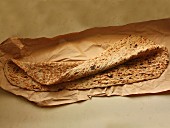 A large flatbread on brown paper