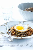 Lentils with fried onions and a fried egg