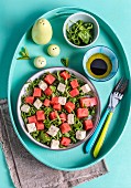 Vegan feta and watermelon salad with mint and rocket (top view)