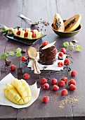 A chocolate cake with raspberries and exotic fruits