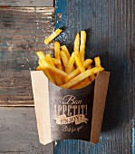 A box of golden french fries sprinkled with salt