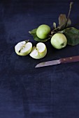 Green apples, whole and halved