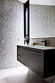 Modern vanity unit in the bathroom with mosaic tiles