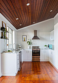 White kitchen under the sloping ceiling with covered ceiling
