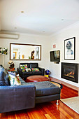 Leather furniture, fireplace, TV and wall mirror in the living room