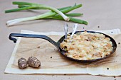 Jerusalem artichoke bake with spring onions, bacon and cheese