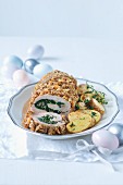 A veal roll filled with spinach and served with fried potatoes at Easter