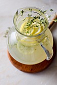 Thyme lemonade in a glass pitcher
