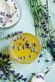 Organic raw honey and white sugar in glass jars flavored with lavender flowers