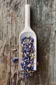 Dried cornflowers on a wooden scoop