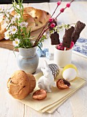 Vegan Easter bread, chocolate rabbits, chocolate eggs and a bouquet of flowers