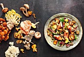 Mushroom salad with rabbit fillets wrapped in bacon, and various raw mushrooms