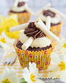 Cupcakes with buttercream and white chocolate rolls