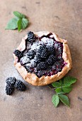 Blackberry galette with icing sugar