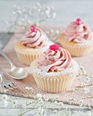 Cupcakes with buttercream and a pink jelly bean
