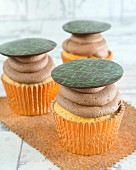 Cupcakes with chocolate cream and chocolate disks