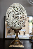 Engraved ostrich egg on metal stand