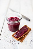 Beetroot spread in a glass and on bread