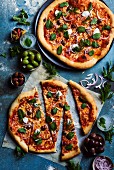 Pizza with mozzarella, olives and mint