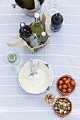Ingredients for starters and drinks on terrace table seen from above