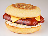 An English muffin with egg, sausage and cheese