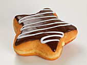 A star-shaped doughnut with chocolate glazing