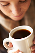 Woman holding a cup of coffee