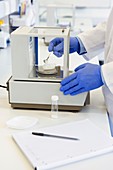 Scientist weighing out a chemical sample