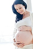 Pregnant woman touching tummy