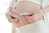 Pregnant woman measuring tummy