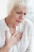 Senior woman touching chest