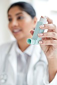 Female doctor holding inhaler