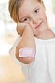 Young girl with plaster on elbow
